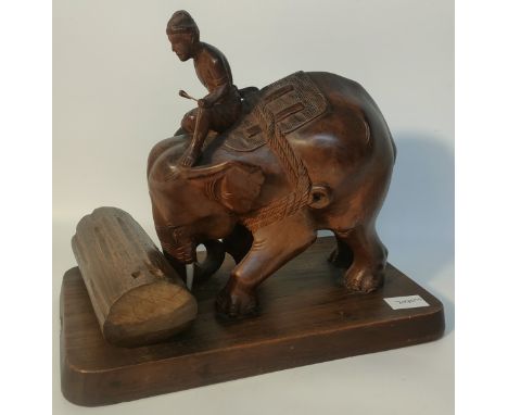 Genuine Burma Teak elephant &amp; rider sculpture pushing a tree trunk supported on a wooden plinth [stated at the bottom of 