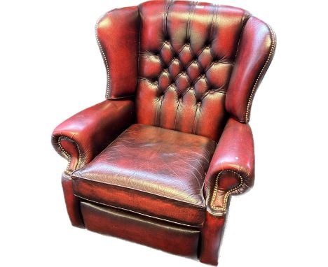 Chesterfield reclining lounge chair, covered in a red leather button upholstery 