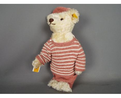 Steiff - An unboxed Steiff Classic teddy bear in white mohair with yellow tag #027567, measuring approximately 33cm in height