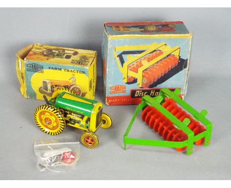 Mettoy Playthings - A boxed Mettoy Playthings Mechanical Farm Tractor #6435. The tinplate tractor in green, yellow and red wi