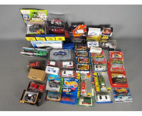 A collection of over 30 boxed / carded predominately 1:64 scale and similar diecast vehicles. Lot includes Matchbox MB21 Niss