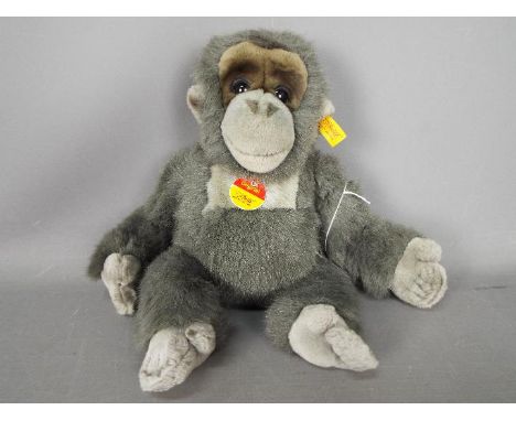 Steiff - A Steiff 'Little Baby Gorilla' #062070. This grey plush gorilla stuffed with synthetic filling and measures approxim