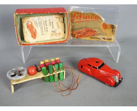 Schuco - A boxed Schuco 3000 Telesteering Car. The tinplate clockwork car finished in red, is in a presentation box with 12 w