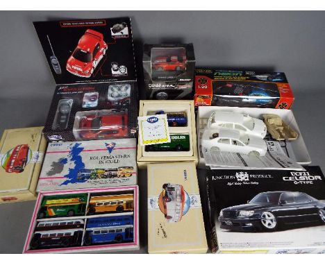 A mixed lot containing 4 boxed diecast vehicles by Corgi, three boxed plastic RC cars, and a boxed Aoshima plastic model kit.