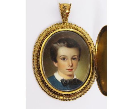 A 19th Century portrait miniature on ivory depicting a young boy, in gilt metal pendant locket with slide off cover, 5cm x 7.