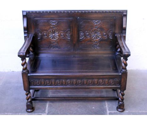 A 1920s oak monk's bench. W97cm D52cm H69cm