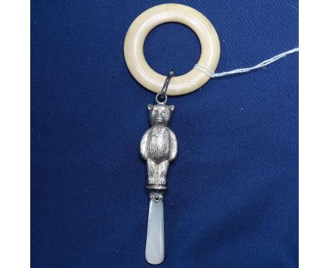 A teddy bear design silver baby's rattle, with mother-of-pearl handle and ivory teething ring 