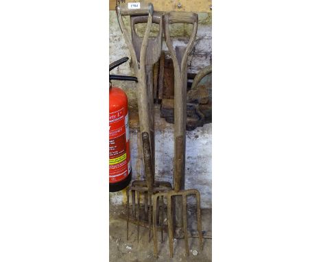 4 long-handled forks and a pick axe 