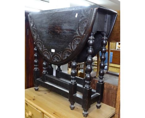 A carved oak oval gateleg table on bobbin-turned legs, W75cm 