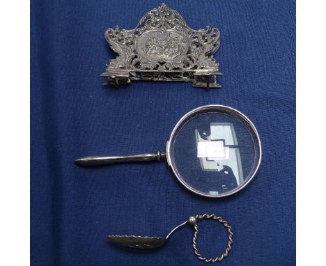 A Swedish silver letter rack, a Norwegian finger spoon, and a silver-handle magnifying glass 