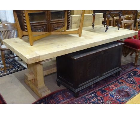 A large light oak plank-top dining table, raised on tablet ends, L220cm, with 2 additional spare leaves extending to L320cm, 