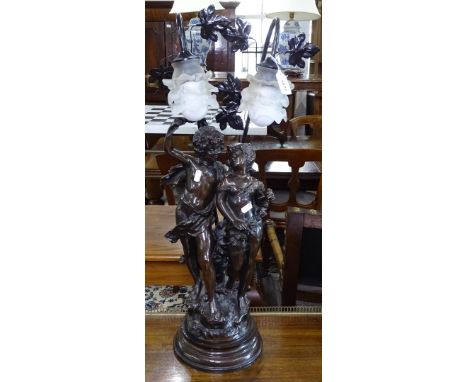 An Art Nouveau style patinated 2-branch table lamp, supported by 2 cherubs, H79cm 