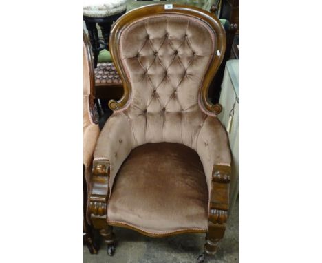 A Victorian button-back and carved mahogany-framed armchair 