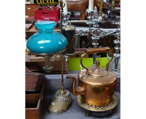 An adjustable brass oil desk lamp on horse's hoof base, copper kettle, and trivet 