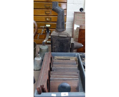 A tinplate magic lantern, and a quantity of coloured glass slides depicting animals, ships etc 