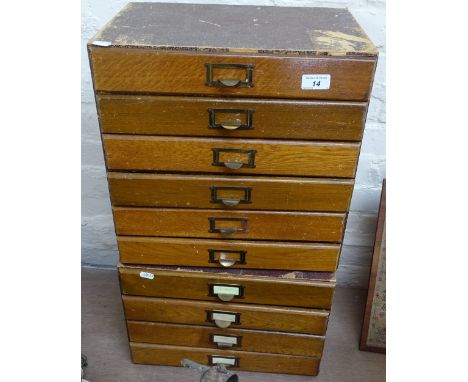 An oak-fronted Vintage bank of 6 drawers, height 15.5", and a matching bank of 4 filing drawers 