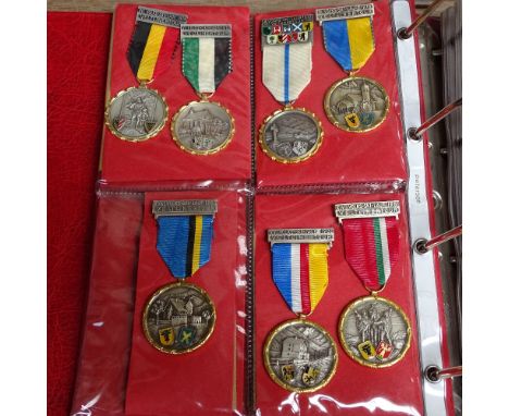 An album of Vintage Continental sporting medallions etc 