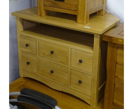A modern light oak TV stand with 6 fitted drawers, W84cm 