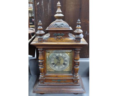 A carved oak-cased 2-train mantel clock, 18" 
