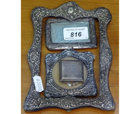 A rectangular embossed silver frame, 2 small silver-fronted photo frames, and a small silver-cased travelling clock 