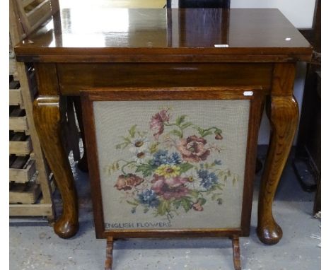 An oak-framed firescreen, and a fold over table on cabriole legs 