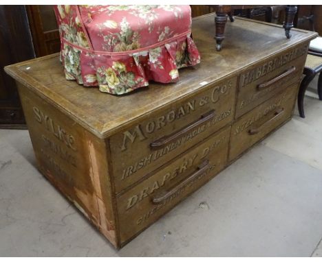 A large Vintage shop haberdashery cabinet of centre standing form, with 4 fitted drawers and all over advertising script, for