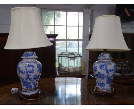 A pair of blue and white glazed ceramic baluster table lamps and shades, height including shade 62cm 