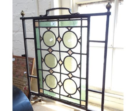Antique wrought-iron framed firescreen, with leadlight glass panels and brass finials, height 28.5" 