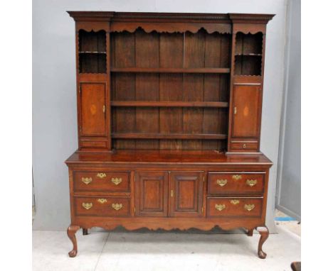 A Georgian style oak, crossbanded and inlaid Dresser with display back, ogee moulded cornice with dentil frieze, shaped apron