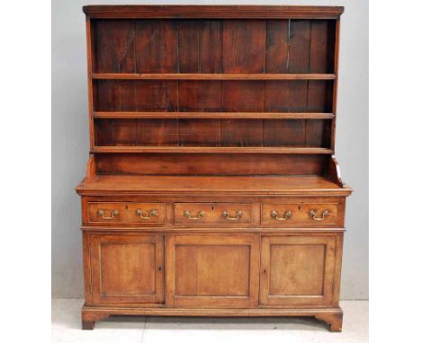 An 18th century Georgian Elm Dresser, the rectangular pot board with plain cornice, vertically boarded behind three shelves i