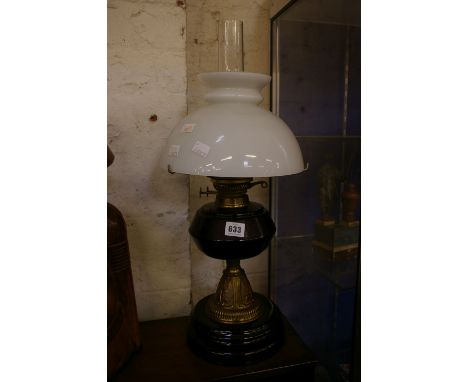 A Victorian oil lamp, with amethyst glass reservoir, 35cm high excluding chimney and shade