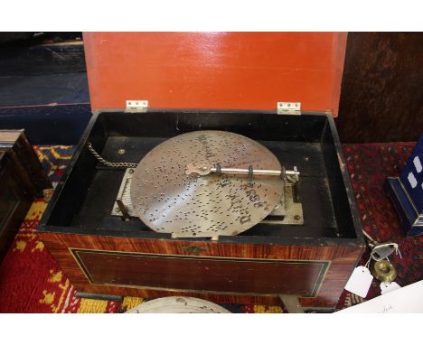 A polyphone disc player with 9cm comb playing 21cm (8.5 width) discs housed in a comb grained box with side handles and front