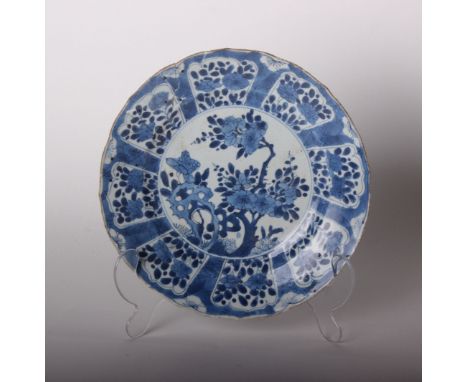 A Chinese blue and white dish, Kangxi, the centre painted with flowers issuing from pierced rockwork, 28.4cm diameter, with o
