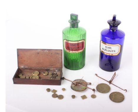 Two coloured glass chemist bottles, both labelled (green & blue) and two small beam scales with assorted weights and one wood