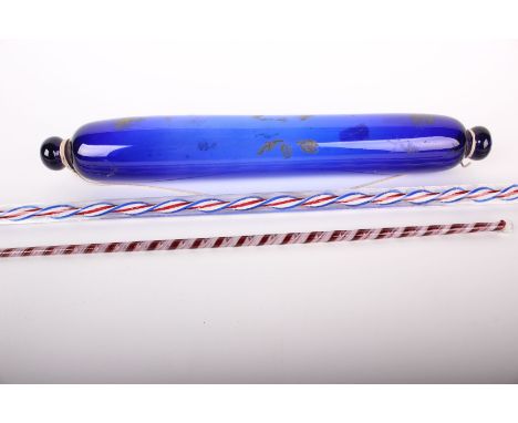 A 19th Century Nailsea walking stick, three colour twist (98cm), a colour twist swizzle stick and blue rolling pin, 36cm 