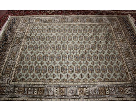 A green ground Bokhara carpet, 230cm x 160cm.