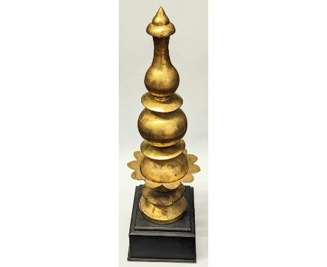 A rare 18-19th century Mughal Indian gilded copper architectural finial, mounted on wooden base, H.58cm (including base)