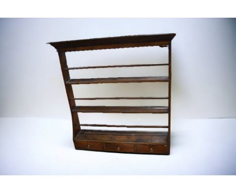 An 18th century oak dresser plate rack with three spice drawers to base, and dentil moulding to the frieze.&nbsp;Dimensions: 