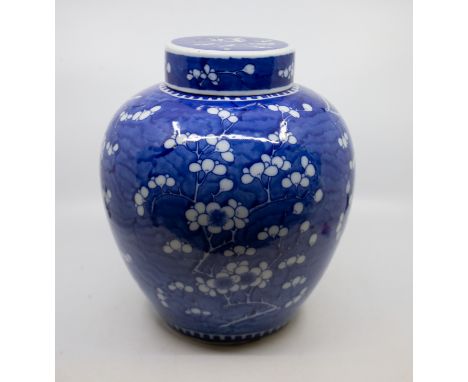 A Chinese blue and white large ginger jar and cover, the cover and body profusely decorated with prunus, approx 30cm high   C