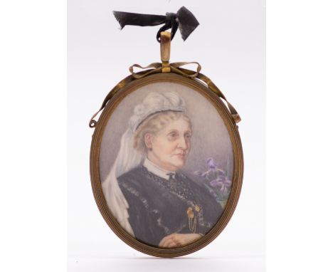 Victorian School Portrait of an elderly Woman black dress, white mantilla with iris to background oval, 7cm long, gilt metal 