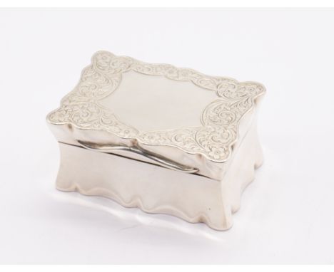 A Georgian style silver table snuff box, rectangular with wavy border, the cover and underside engraved with scrolling foliat