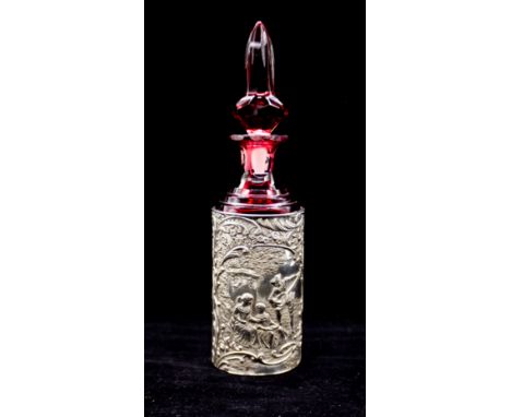 A late Victorian silver bottle holder, the cylindrical holder chased with 18th Century Ladies seated by a pedestal with Gentl