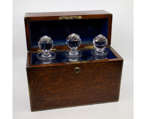 A 19th Century brass bound flame mahogany rectangular three compartment decanter box, fitted with three cut glass spirit deca