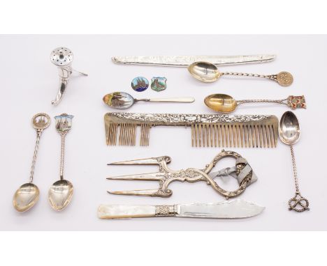 A collection of various silver souvenir spoons and others to include; an 830S standard silver novelty horn mull shaped pepper