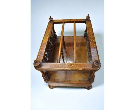 A Victorian walnut Canterbury with pierced sides, front and back turned supports, single base drawer, turned legs on ceramic 