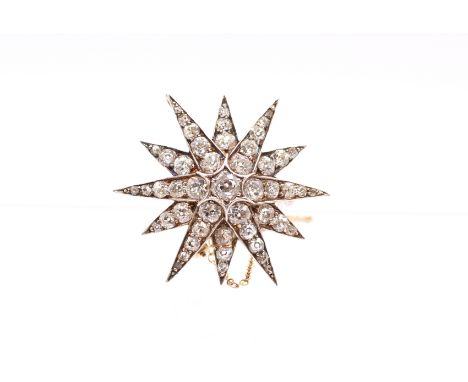 A Victorian diamond and gold star brooch, comprising grain set old European cut diamonds, the principal central stone approx 