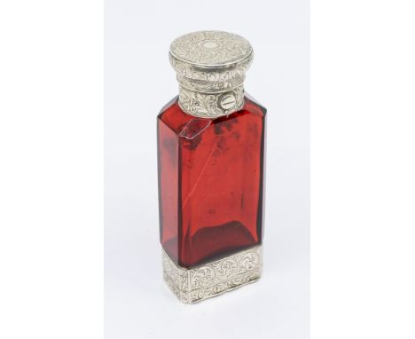 A Victorian silver mounted ruby glass combination scent bottle and vinaigrette, the silver engraved with scrolling foliage, t