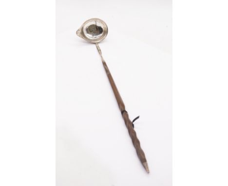 A George III silver toddy ladle, the body engraved with floral festoons and central canted cartouche engraved with initials, 