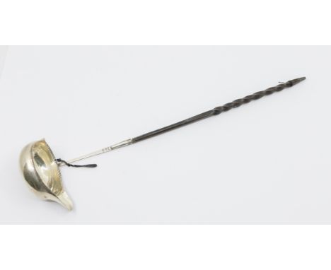 A mid 18th Century silver toddy ladle, beaded rim, the handle engraved with initials MS, twist ebonised handle, marks indisti