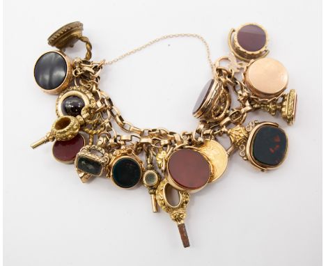 An 19th century unmarked 9ct gold charm bracelet suspending various seals, swivel fobs etc, to include Georgian watch key unm